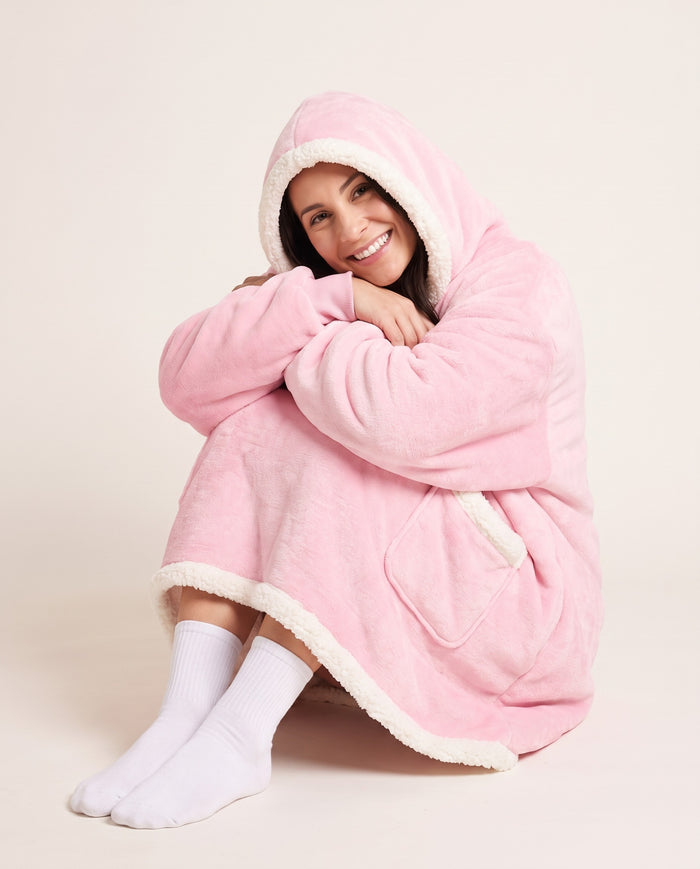 Couchmode Blanket Hoodie in Pink, sitting cozy