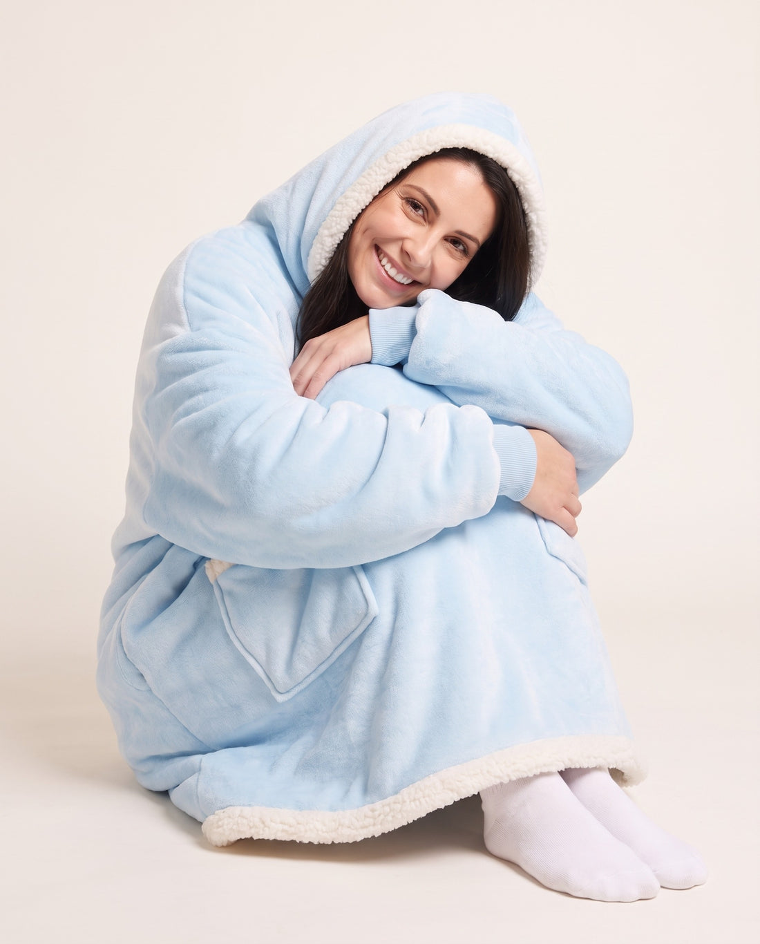 Couchmode Blanket Hoodie in Baby Blue, sitting cozy