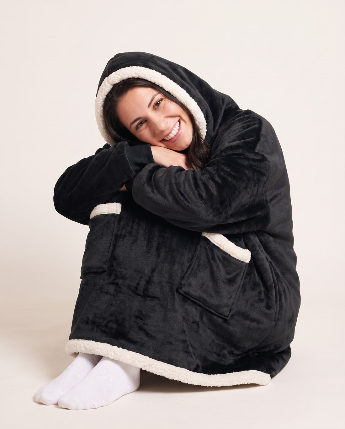 Couchmode Blanket Hoodie in Black, sitting cozy